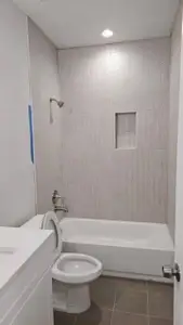 Full bathroom featuring toilet,  shower combination, tile patterned floors, and vanity