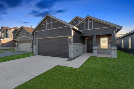 As the sun sets, this home's charming exterior comes alive with warm, inviting tones. The modern design with its clean lines and dual-gabled roof presents a blend of contemporary style and timeless appeal. A well-lit pathway leads to a welcoming entrance, making it the perfect start to your new chapter. **This image is from another Saratoga Home - Clover floorplan.**