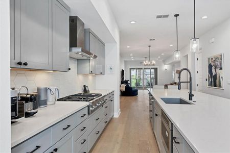 Top-of-the-line Bosch and Thermador appliances, including a gas range, make this kitchen a dream for any cooking enthusiast.