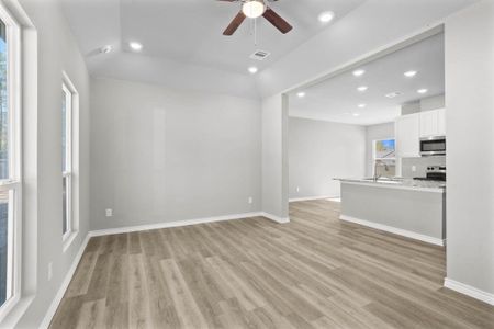 Here you will see the open concept this home has to offer. The dining room is to the left of the kitchen.