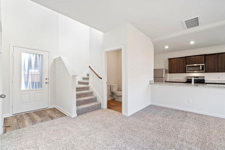 Foyer entrance with light carpet