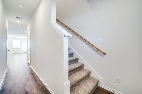 Staircase featuring wood-type flooring