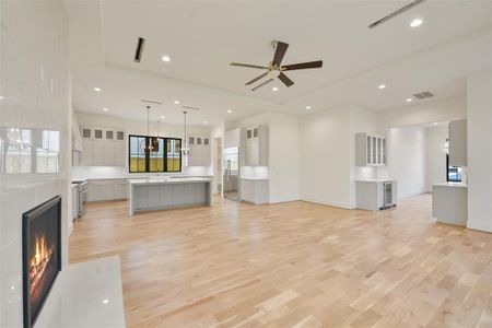 The main living area flows seamlessly between the kitchen, the butler's pantry to the dining room and back to the study. Access to the primary bedroom is offset by a vestibule.