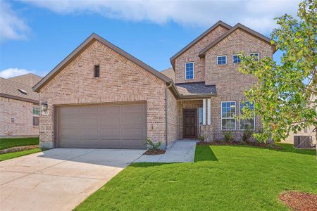 View of front of house featuring a garage, a front lawn, and central AC unit