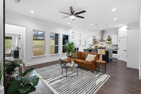 Living room with dark wood-type flooring and ceiling fan