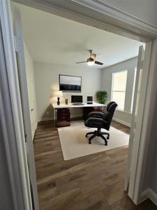 Office area featuring dark hardwood / wood-style flooring and ceiling fan