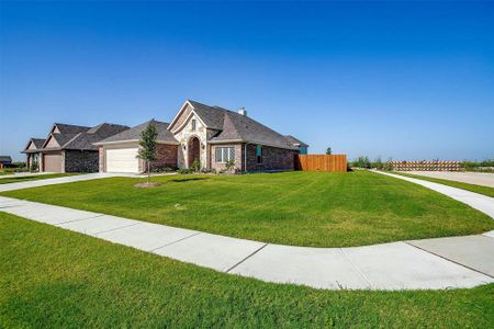 View of front of home with a garage and a front lawn