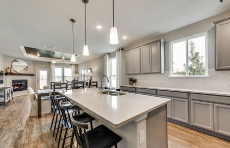 View of dining and gathering room from kitchen isl