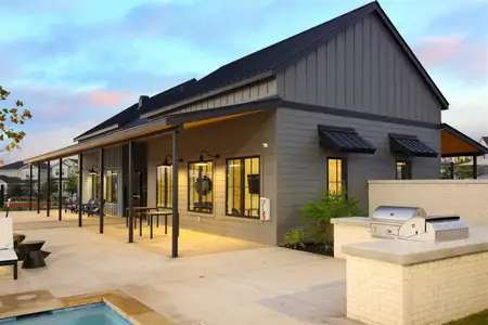 Back of property with a patio, area for grilling, and board and batten siding