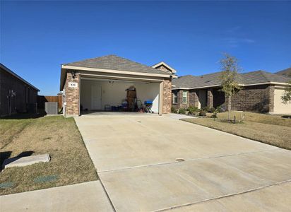 View of front facade featuring a garage, a front yard, and central AC