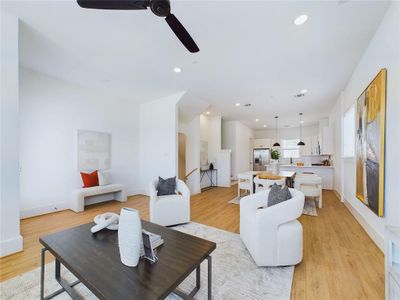 Open concept living and dining space with ample natural lighting.