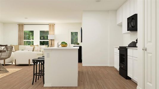 Kitchen featuring range, a breakfast bar, light hardwood / wood-style flooring, and white cabinets