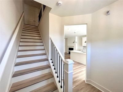 Staircase featuring sink and light hardwood / wood-style flooring