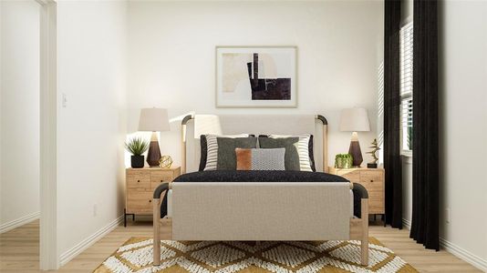 Bedroom with light wood-style flooring and baseboards