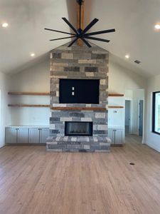 Vaulted Ceilings, Gas Starter Fireplace, Wood Beams in Living Room. 
**construction pictures before owners moved in