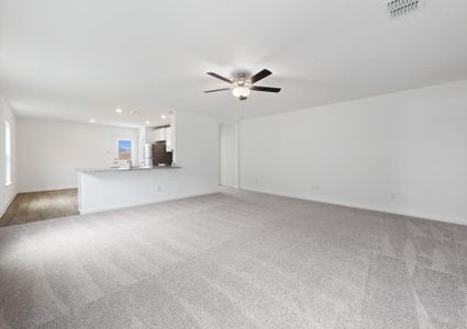 Open layout with a large living room that the kitchen overlooks.