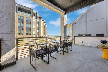 View of patio with a balcony