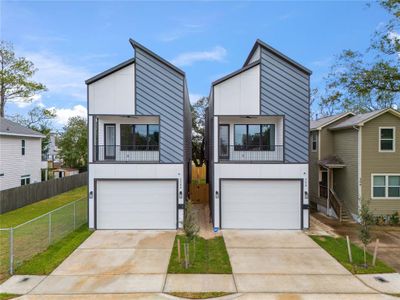 Spacious driveway, inviting balcony, and large windows that let natural light flood the living area, creating an airy, open atmosphere perfect for living and entertaining