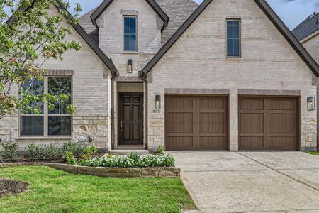 French country home with a front yard and a garage