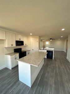 Kitchen with recessed lighting, an island and plenty of cabinets