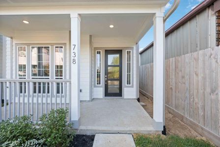 Imagine sipping your morning coffee on this serene front porch, accentuated by neutral paint hues and an elegant 8-foot designer door with side lights.