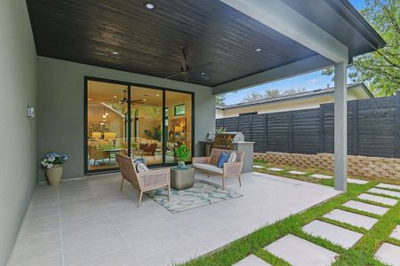 View of patio with ceiling fan and an outdoor kitchen