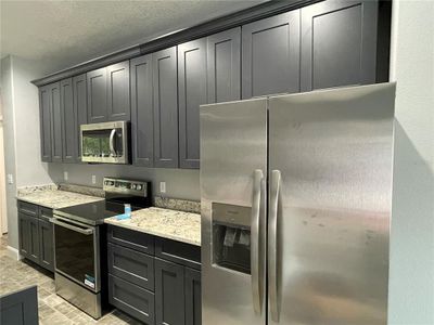 soft close trendy cabinets and stainless steel appliances