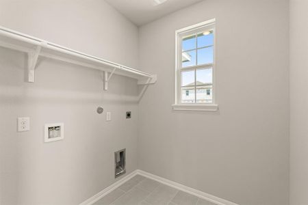 The laundry room layout is carefully planned for optimal workflow with designated areas for washing, drying, and storing.