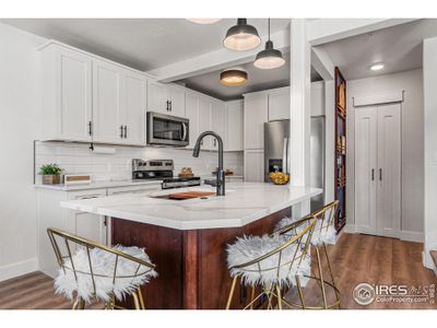 A large quartz island is the heart of the great room.