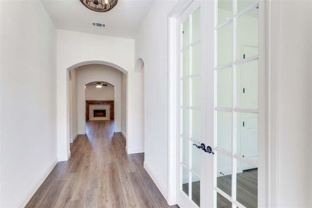 Hall with light hardwood / wood-style floors