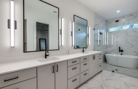 Bathroom with shower, tub and well lit vanity