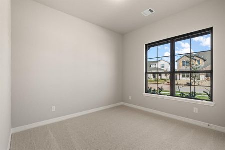 Your secondary bedroom features plush carpet, fresh paint, closet, and a large window that lets in plenty of natural lighting.