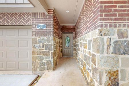 Doorway to property with a garage