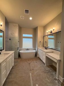 Primary Bath Sneak Peek, Vanity, Dual Sinks with Waist High Countertops, Soaking Tub, Large Framed Mirrors, Oil Rubbed Bronze Fixtures Throughout *Paper covering the Floor*