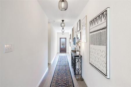 Hall with light hardwood / wood-style flooring