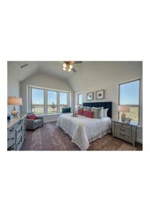 Carpeted bedroom featuring ceiling fan and vaulted ceiling