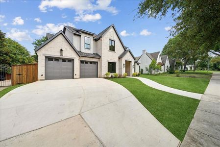 View of front of house featuring a garage and a front yard