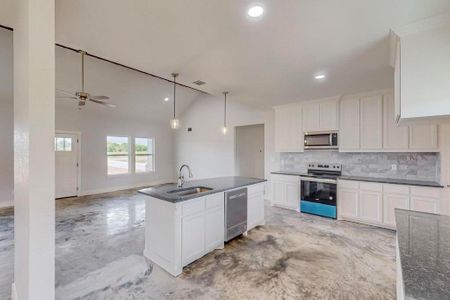 Kitchen featuring white cabinets, ceiling fan, hanging light fixtures, and stainless steel appliances