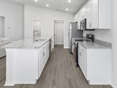 Enjoy a luxuriously appointed kitchen with granite, 36-inch cabinets, Samsung appliances, and a walk-in pantry.