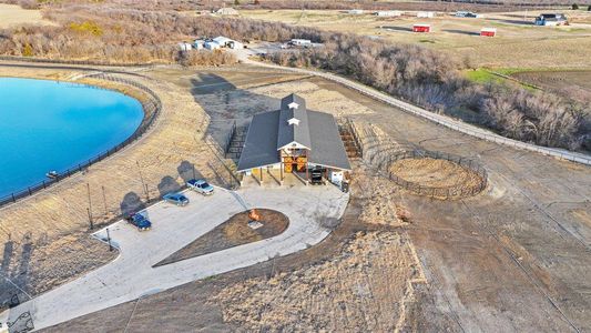 Birds eye view of property with a water view