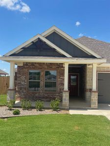 View of front of house featuring a garage and a front yard