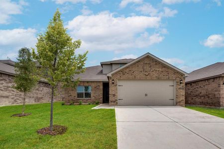 View of front of house featuring a garage and a front lawn