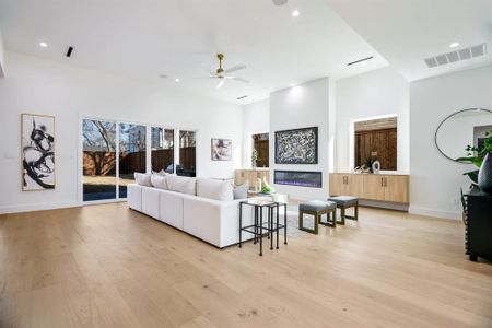 Living room featuring ceiling fan and light hardwood / wood-style flooring