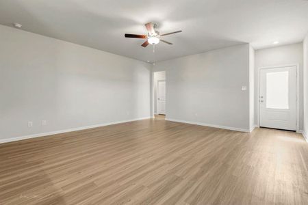 This open-concept living room has beautiful, upgraded vinyl plank flooring.