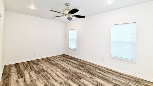 Unfurnished room featuring ceiling fan and wood-type flooring