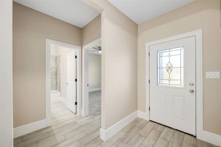 Entryway featuring ceiling fan and light hardwood / wood-style flooring