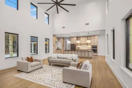 Living area with light wood-type flooring, visible vents, and baseboards