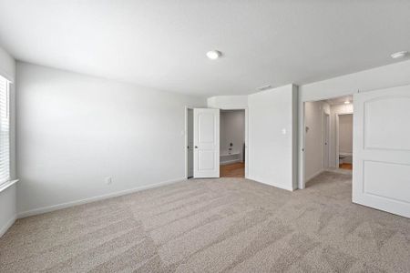 Bedroom featuring light carpet