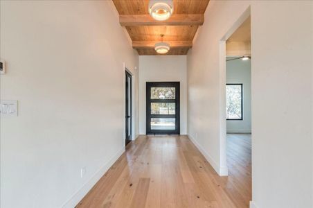 The breathtaking entryway showcases beautiful white oak floors throughout, complemented by 12' and 17' ceilings.