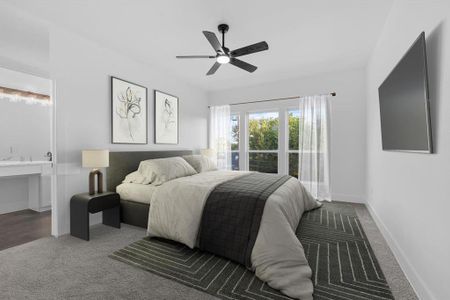 This is a modern virtually staged bedroom with abundant natural light from a large window, featuring a plush bed, an en suite vanity area, sleek ceiling fan, wall-mounted TV, and minimalistic decor.